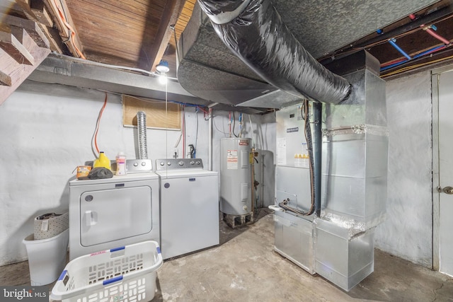 unfinished below grade area featuring water heater, heating unit, and separate washer and dryer