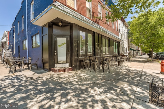 1200 Steuart St Unit 913, Baltimore, MD 21230 - doorway to property with brick siding and outdoor dining space