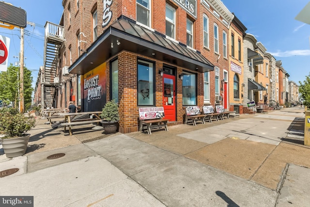 1200 Steuart St Unit 913, Baltimore, MD 21230 - doorway to property featuring brick siding, a standing seam roof, metal roof, and a residential view