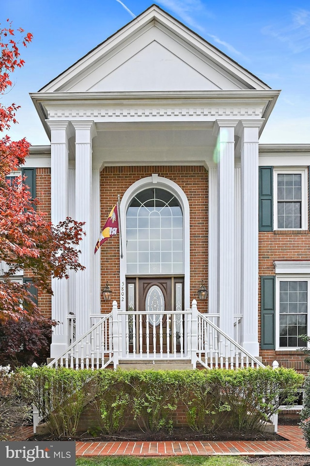 property entrance with brick siding