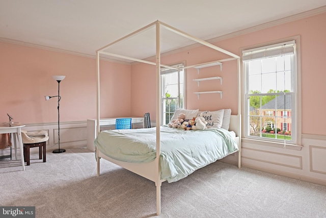 bedroom featuring carpet flooring, ornamental molding, and wainscoting