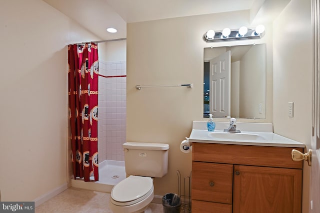 bathroom with baseboards, toilet, vanity, and a stall shower