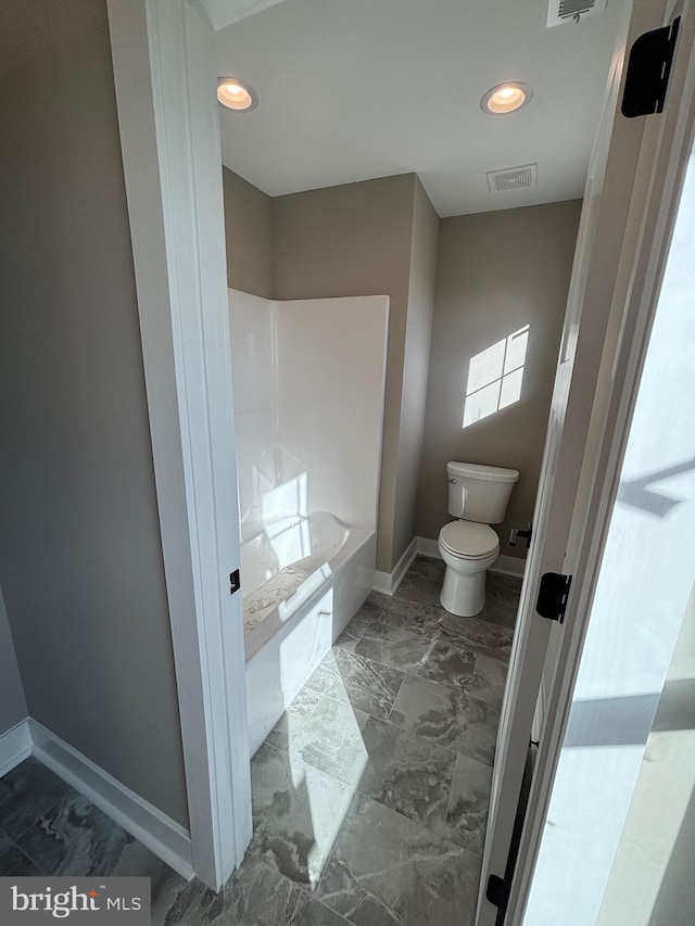bathroom with visible vents, baseboards, toilet, a bathtub, and marble finish floor