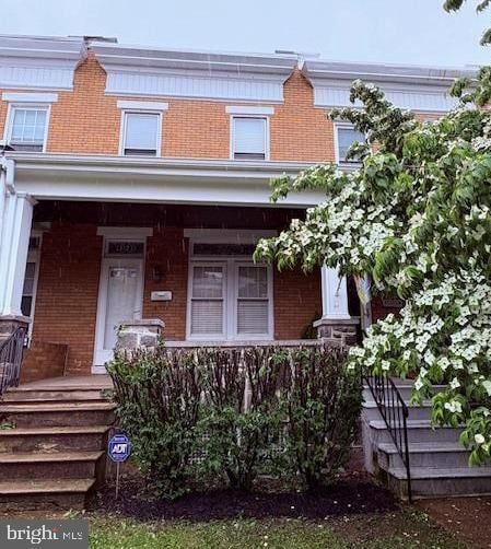 1323 W 41st St, Baltimore, MD 21211 - view of front of house featuring brick siding and covered porch