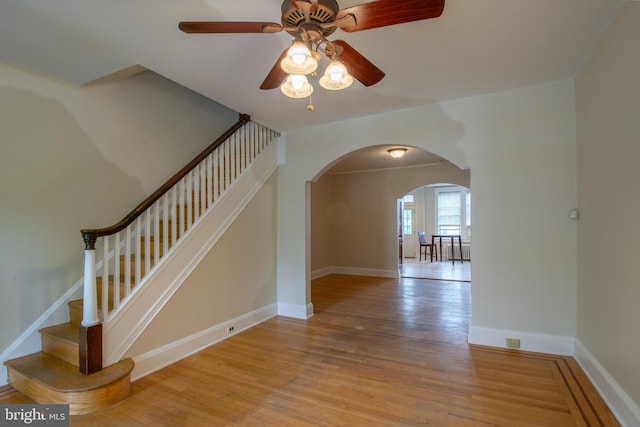 1323 W 41st St, Baltimore, MD 21211 - stairs with arched walkways, wood finished floors, ceiling fan, and baseboards