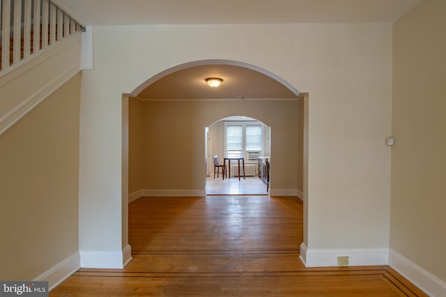 1323 W 41st St, Baltimore, MD 21211 - hallway featuring wood finished floors, arched walkways, and baseboards