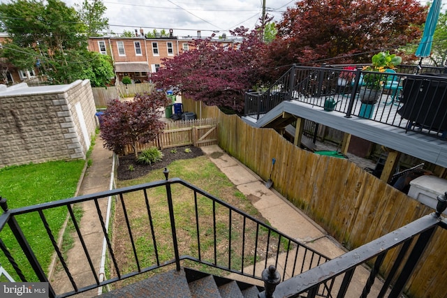 1323 W 41st St, Baltimore, MD 21211 - fenced backyard featuring stairway and a wooden deck