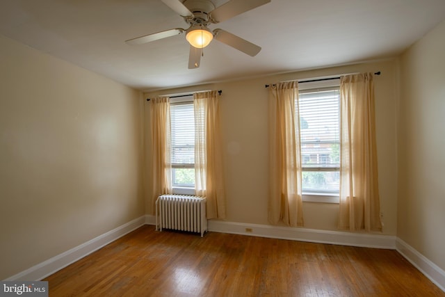 1323 W 41st St, Baltimore, MD 21211 - empty room featuring radiator, wood finished floors, baseboards, and a ceiling fan