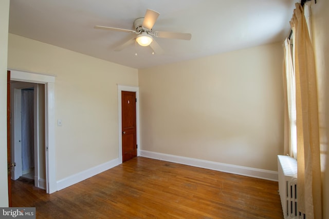 1323 W 41st St, Baltimore, MD 21211 - spare room with baseboards, wood finished floors, radiator, and a ceiling fan