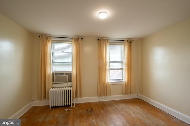 1323 W 41st St, Baltimore, MD 21211 - spare room featuring radiator, wood finished floors, baseboards, and cooling unit