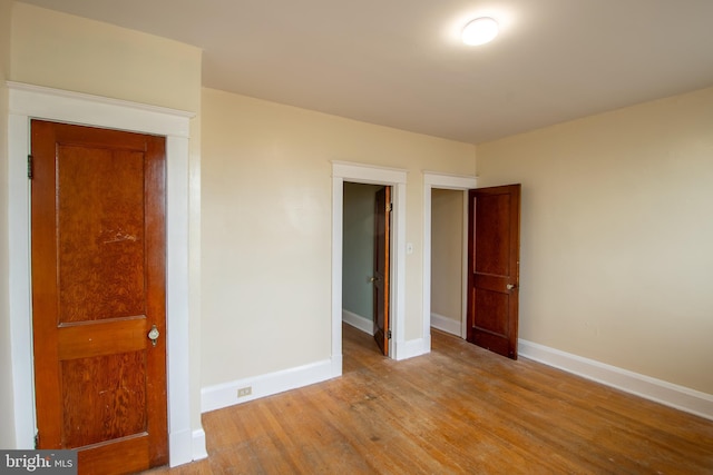 1323 W 41st St, Baltimore, MD 21211 - unfurnished bedroom with baseboards and wood finished floors