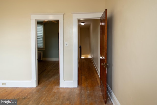 1323 W 41st St, Baltimore, MD 21211 - hall featuring radiator, wood finished floors, and baseboards