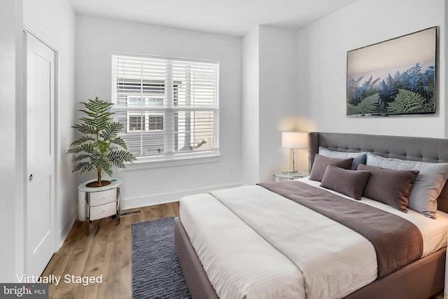 bedroom featuring wood finished floors and baseboards
