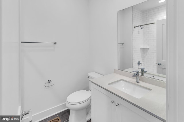 full bath featuring baseboard heating, vanity, baseboards, walk in shower, and toilet