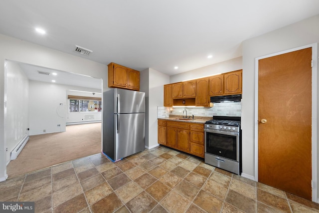 14B Heron St S, Manchester Township, NJ 08759 - kitchen with light countertops, under cabinet range hood, a baseboard heating unit, a sink, and appliances with stainless steel finishes