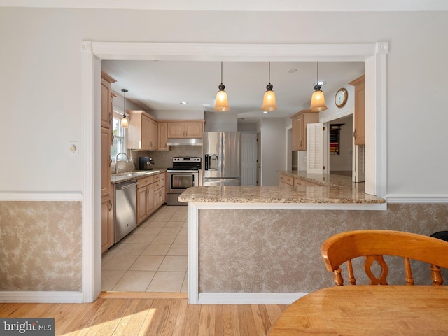 59 Hagan Dr, New Hope, PA 18938 - kitchen featuring a sink, appliances with stainless steel finishes, light brown cabinets, under cabinet range hood, and a peninsula
