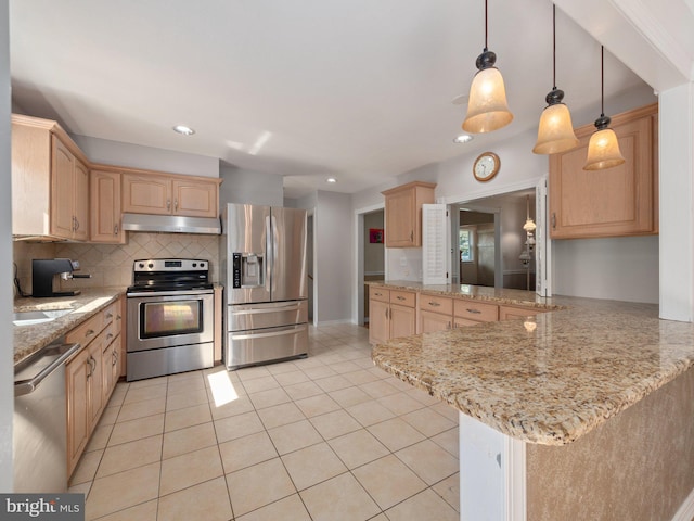 59 Hagan Dr, New Hope, PA 18938 - kitchen with under cabinet range hood, light brown cabinets, backsplash, a peninsula, and appliances with stainless steel finishes