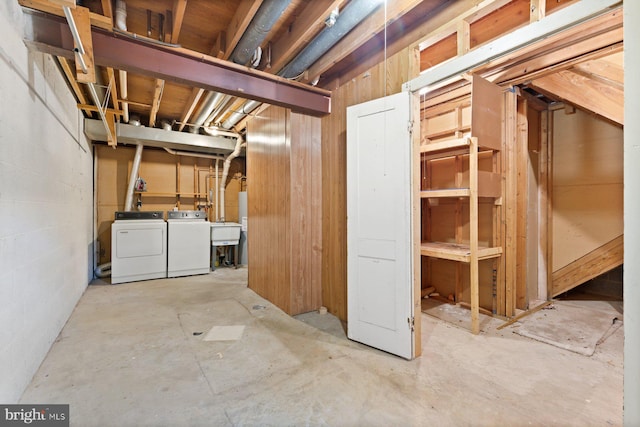 unfinished basement featuring independent washer and dryer and a sink