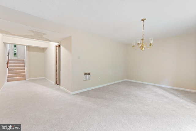 unfurnished room with light carpet, a chandelier, stairs, and baseboards