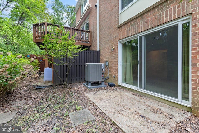 view of yard with central AC and a wooden deck