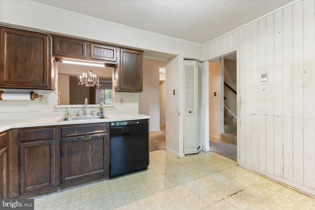 kitchen with black dishwasher, a sink, a chandelier, dark brown cabinets, and a textured ceiling