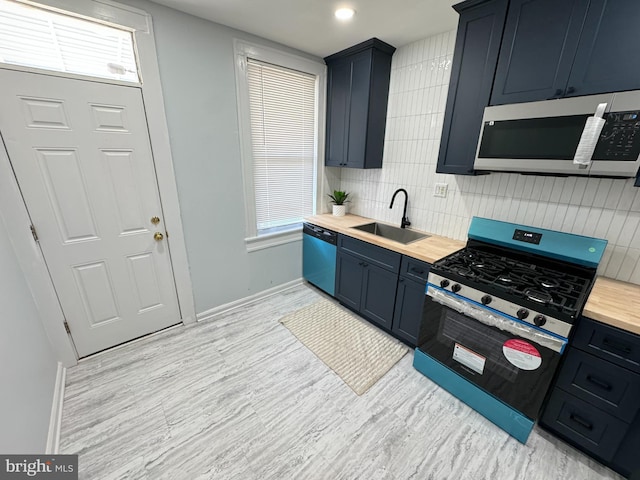 kitchen with decorative backsplash, wooden counters, dishwasher, gas stove, and a sink