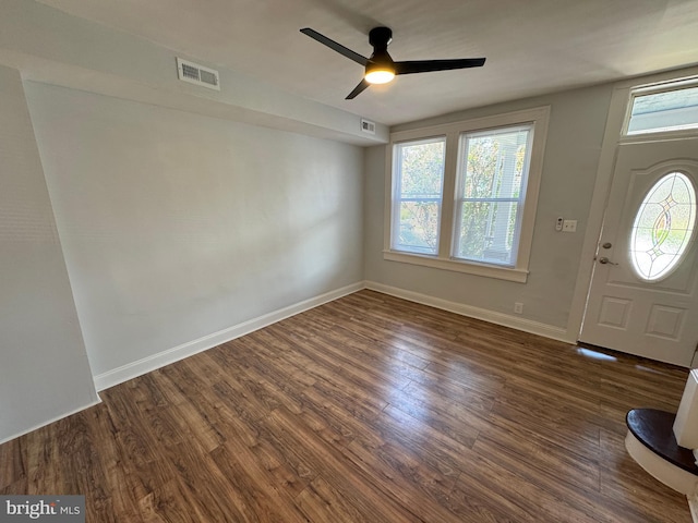 foyer with baseboards, ceiling fan, dark wood-style floors, and visible vents