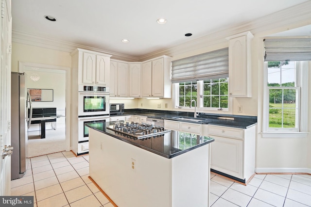 8233 Gallery Ct, Gaithersburg, MD 20886 - kitchen with a sink, appliances with stainless steel finishes, light tile patterned floors, ornamental molding, and a center island