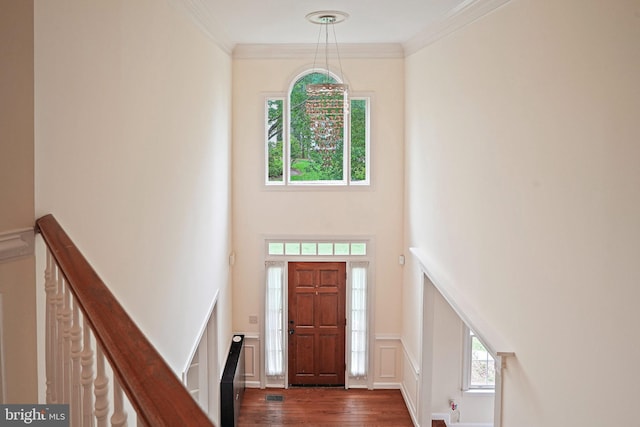 8233 Gallery Ct, Gaithersburg, MD 20886 - foyer with dark wood-type flooring, crown molding, wainscoting, a decorative wall, and a towering ceiling