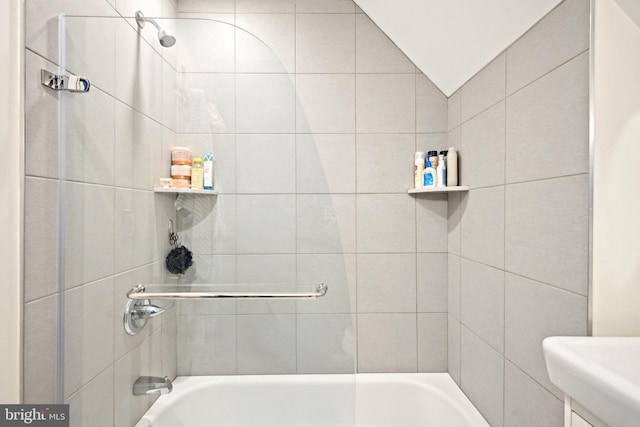 bathroom featuring shower / washtub combination and vaulted ceiling