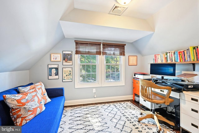home office featuring wood finished floors, baseboards, vaulted ceiling, and visible vents