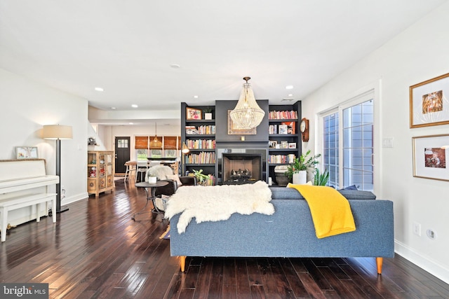 living room featuring a fireplace, wood-type flooring, and a wealth of natural light