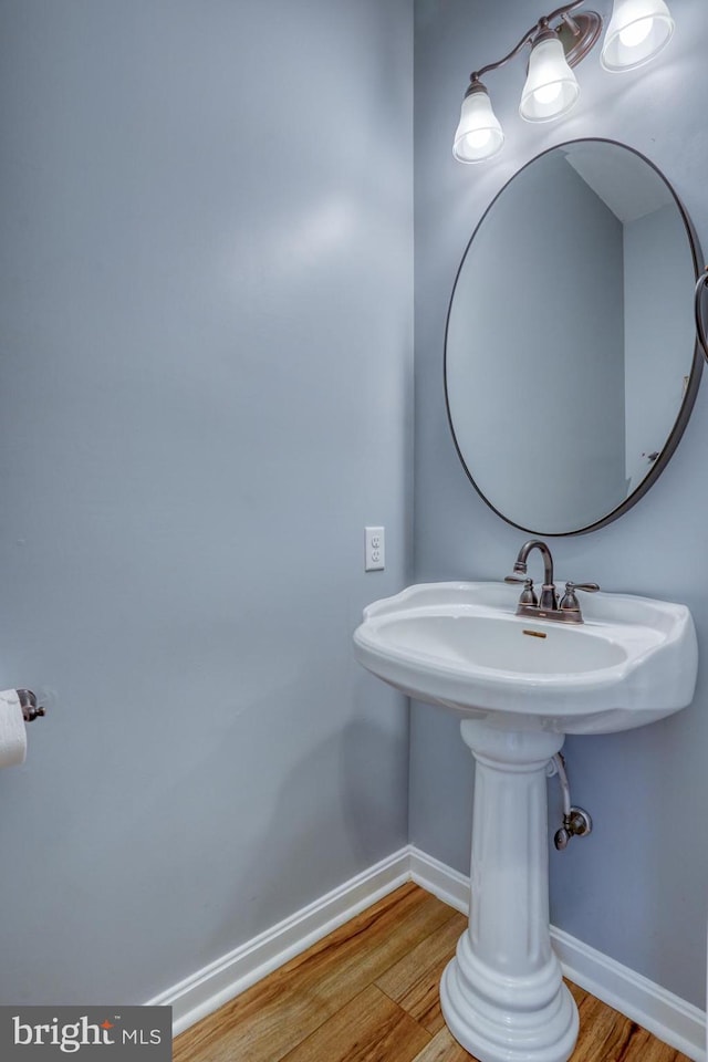bathroom with wood finished floors and baseboards