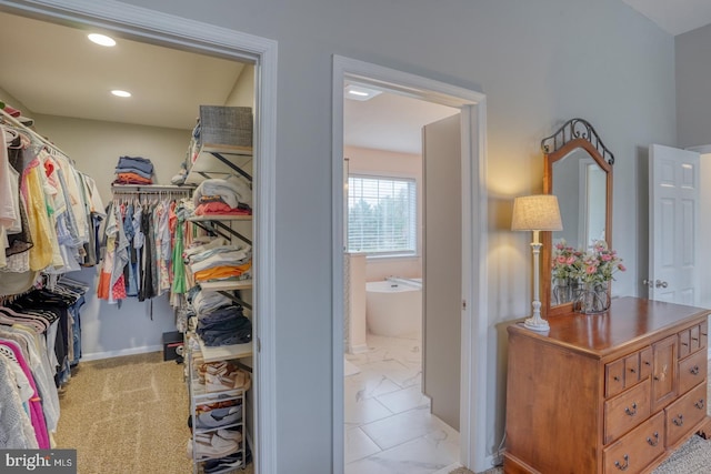 spacious closet with marble finish floor