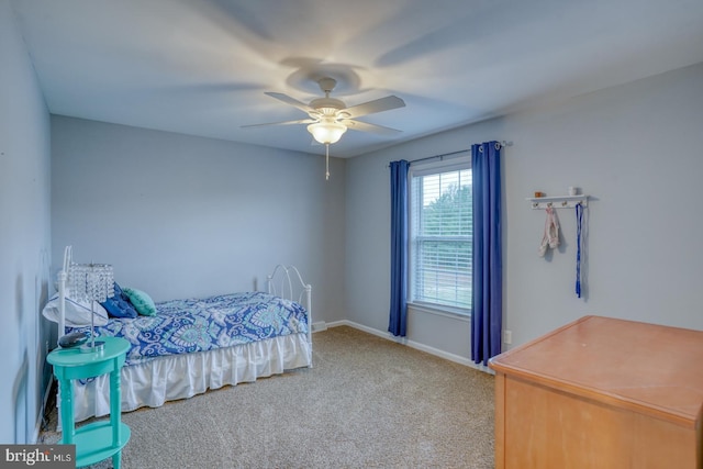 carpeted bedroom with baseboards and ceiling fan