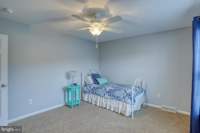 carpeted bedroom with ceiling fan, baseboards, and visible vents