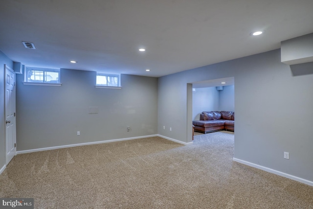 below grade area featuring baseboards, carpet floors, visible vents, and recessed lighting