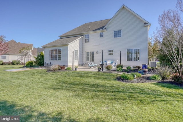 back of property featuring a patio area and a lawn