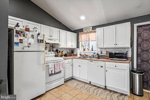 7443 Tamara Ln, Tobyhanna, PA 18466 - kitchen with tasteful backsplash, under cabinet range hood, white appliances, and vaulted ceiling