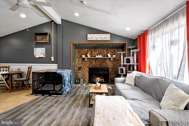 7443 Tamara Ln, Tobyhanna, PA 18466 - living room featuring lofted ceiling with beams, a ceiling fan, a fireplace, wainscoting, and wood finished floors