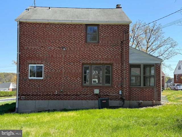 6134 Marglenn Ave, Baltimore, MD 21206 - view of home's exterior with a lawn, brick siding, and central AC