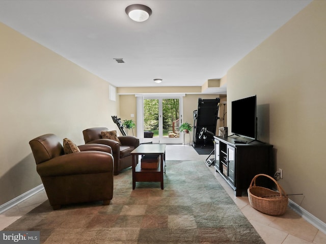 living area featuring visible vents, baseboards, and light tile patterned floors