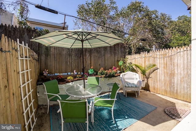 view of patio / terrace with outdoor dining area and fence