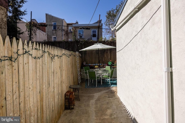exterior space with outdoor dining space and fence