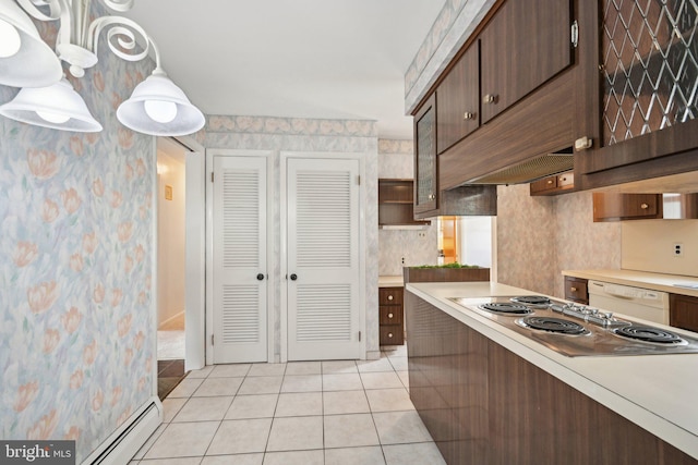 kitchen with white dishwasher, stovetop, light countertops, and light tile patterned floors