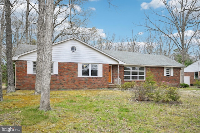 ranch-style home with a front lawn and brick siding