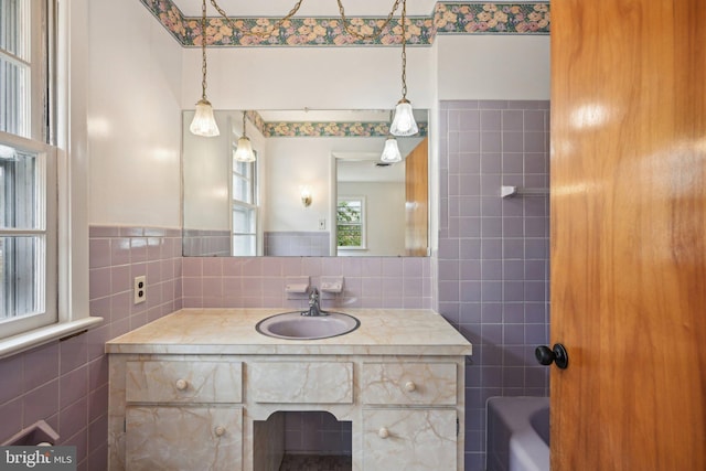 full bathroom with vanity and tile walls