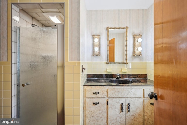 full bath with tasteful backsplash, vanity, and a stall shower