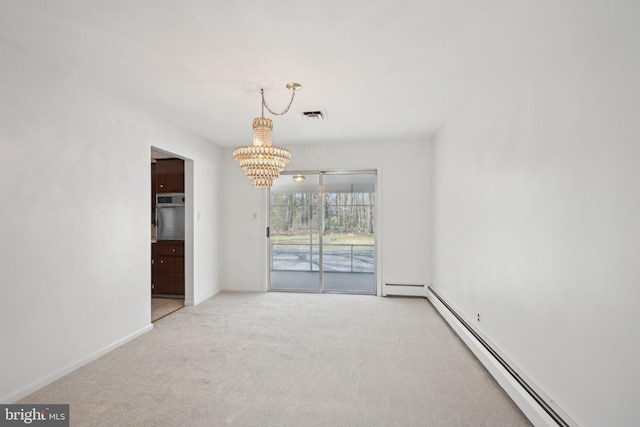 unfurnished dining area with an inviting chandelier, visible vents, carpet floors, baseboards, and a baseboard radiator