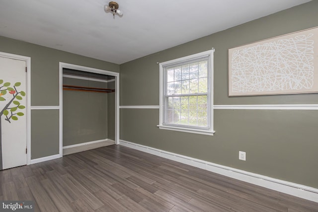 unfurnished bedroom with baseboards and wood finished floors